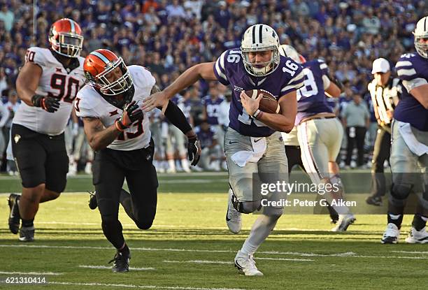 Quarterback Jesse Ertz of the Kansas State Wildcats rushes up field against free safety Jordan Sterns of the Oklahoma State Cowboys during the second...