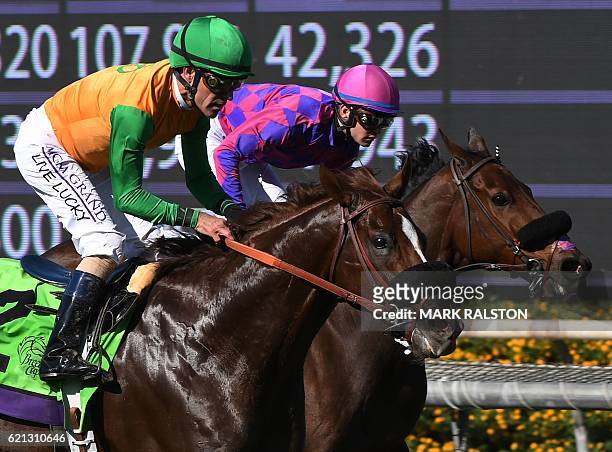 Jockey Flavien Prat riding Obviously wins the Breeders' Cup Turf Sprint race from Om ridden by Gary Stevens during day two of the 2016 Breeders' Cup...