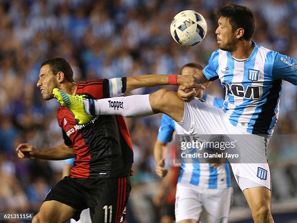 Maximiliano Rodriguez, of Newell's Old Boys, and Sergio Vittor, of Racing Club, struggle for the ball during a match between Racing Club and Newell's...