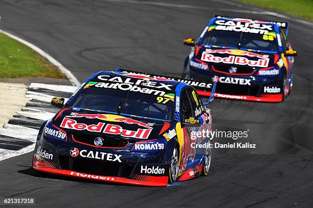 Shane Van Gisbergen drives the Red Bull Racing Australia Holden Commodore VF leads Jamie Whincup drives the Red Bull Racing Australia Holden...