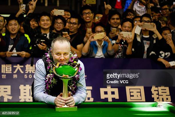 John Higgins of Scotland poses with his trophy after winning Stuart Bingham of England in the final match on Day five of Evergrande China...
