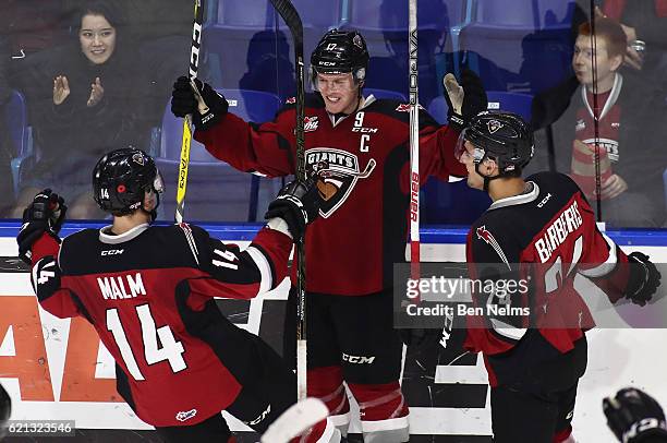Tyler Benson of the Vancouver Giants celebrates his goal against the Lethbridge Hurricanes with teammates James Malm and Matt Barberis during the...