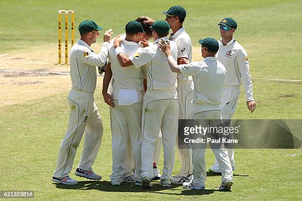 Mitch Marsh of Australia is congratulated by team mates after dismissing Quinton de Kock of South Africa during day four of the First Test match...