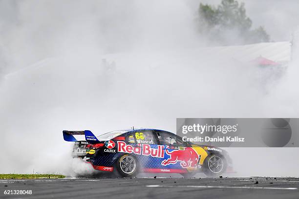 Jamie Whincup drives the Red Bull Racing Australia Holden Commodore VF celebrates with a burnout after winning race 4 for the Supercars Auckland...