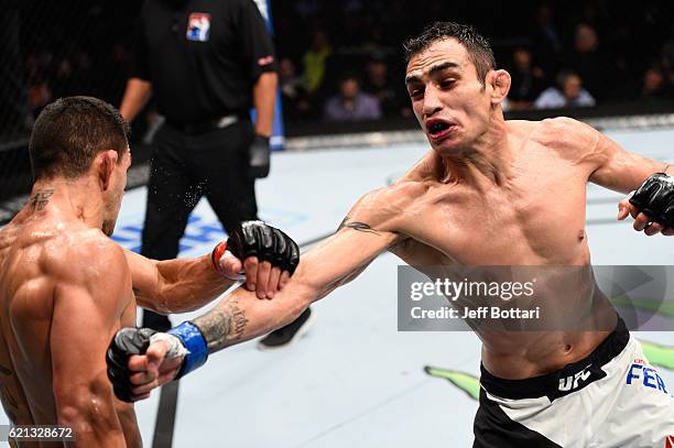 Tony Ferguson of the United States punches Rafael Dos Anjos of Brazil in their lightweight bout during the UFC Fight Night event at Arena Ciudad de...