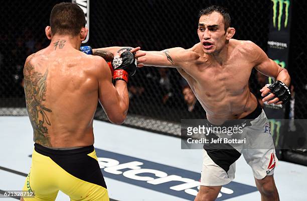 Tony Ferguson of the United States punches Rafael Dos Anjos of Brazil in their lightweight bout during the UFC Fight Night event at Arena Ciudad de...