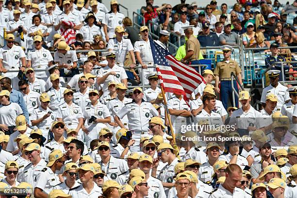 The American flag is proudly presented within the student section during an NCAA football game between Notre Dame and Navy on November 5, 2016 at...