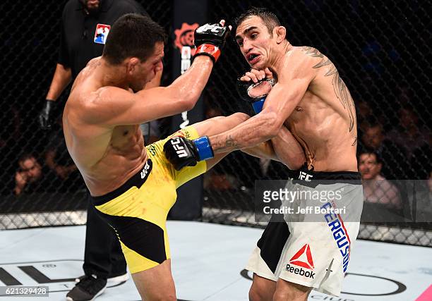 Rafael Dos Anjos of Brazil kicks Tony Ferguson of the United States in their lightweight bout during the UFC Fight Night event at Arena Ciudad de...