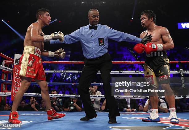 Jessie Vargas and Manny Pacquiao of the Philippines are separated by referee Kenny Bayless during their WBO welterweight championship fight at the...