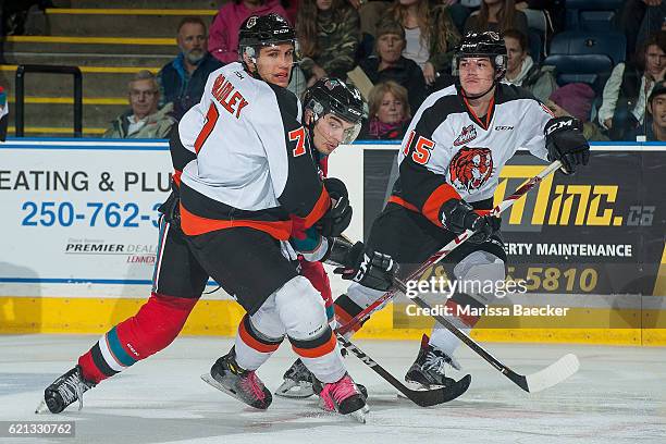 Nick Merkley of the Kelowna Rockets looks for the pass between Ty Schultz and Matt Bradley of the Medicine Hat Tigers during the third period at...
