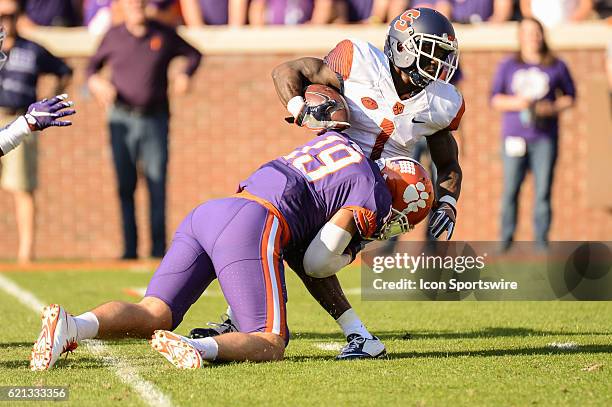 Clemson's Tanner Muse tackles Syracuses Brisly Estime during 1st half action between the Clemson Tigers and the Syracuse Orange on November 5 at...