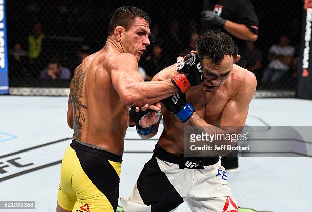 Rafael Dos Anjos of Brazil punches Tony Ferguson of the United States in their lightweight bout during the UFC Fight Night event at Arena Ciudad de...