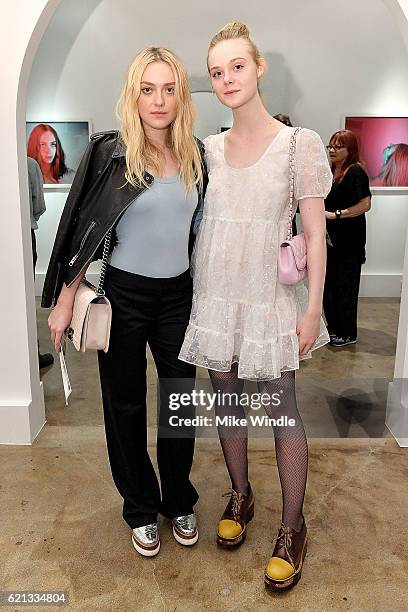 Actors Dakota Fanning and Elle Fanning attend the opening of the Anton Yelchin photography exhibit at Other Gallery on November 5, 2016 in Los...