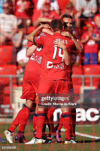 Sergio Guardiola of Adelaide United celebrates with teammates after scoring a goal from a penalty kick during the round five A-League match between...