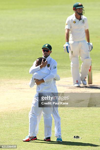 Faf du Plessis of South Africa hugs Temba Bavuma after running out David Warner of Australia during day four of the First Test match between...