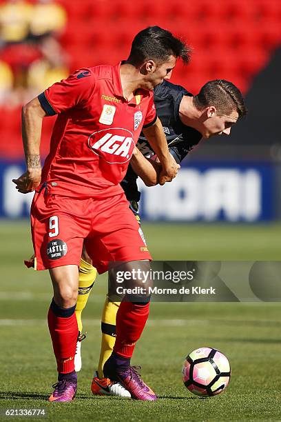 Sergio Guardiola of Adelaide United competes for the ball with Jake McGing of the Central Coast Mariners during the round five A-League match between...