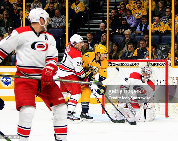 Carolina Hurricanes defenseman Justin Faulk defends against Nashville Predators left wing Colin Wilson as Hurricanes goalie Cam Ward prepares to make...