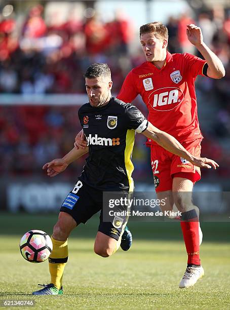 Nick Montgomery of the Central Coast Mariners gets away from Ryan Kitto of Adelaide United during the round five A-League match between Adelaide...