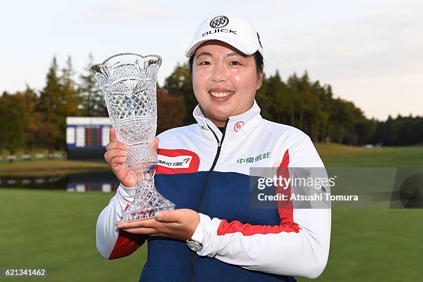 Shanshan Feng of China poses with the trophy after winning the TOTO Japan Classics 2016 at the Taiheiyo Club Minori Course on November 6, 2016 in...