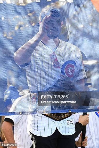 Chicago Cubs third baseman Kris Bryant peaks through a banner during the Chicago Cubs World Series victory rally on November 4 at Grant Park in...