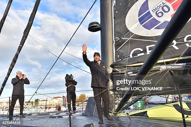 English skipper Alex Thomson waves goodbye from his class Imoca monohull "Hugo Boss" before leaving to take the start of the Vendee Globe solo...