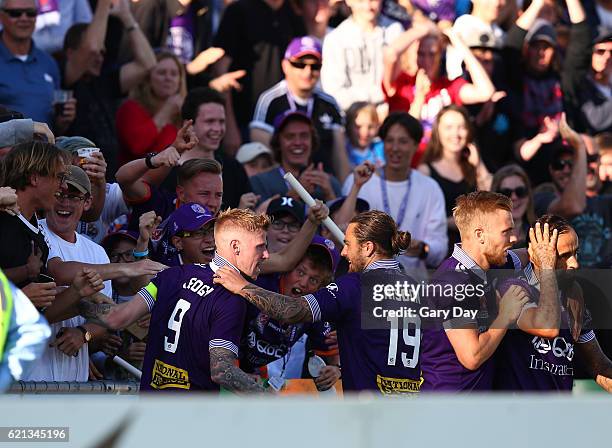 Andrew Keogh of the Glory celebrates scoring a goal with the Glory fans and Joshua Risdon during the round five A-League match between the Perth...