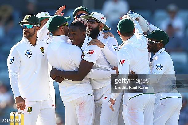 Kagiso Rabada of South Africa celebrates with team mates after dismissing Steve Smith of Australia during day four of the First Test match between...