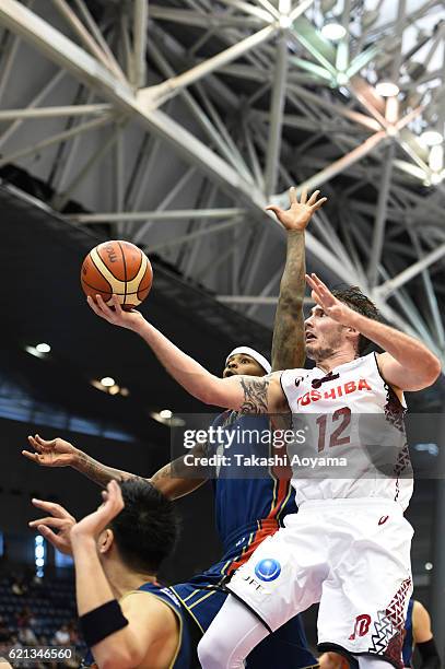 Ryan Spangler of the Kawasaki Brave Thunders tries to shoot under pressure from Jeffrey Parmer of the Yokohama B-Corsairs during the B. League match...