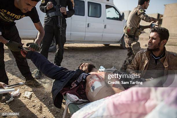 Iraqi Special Forces medics help treat a wounded civilian in the Zahara neighbourhood on the north eastern edge of Mosul as fighting continues...