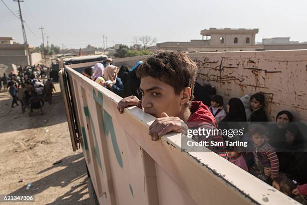 Civilians are loaded onto lorries as they flee from the Zahara neighbourhood on the north eastern edge of Mosul as fighting continues nearby, on...