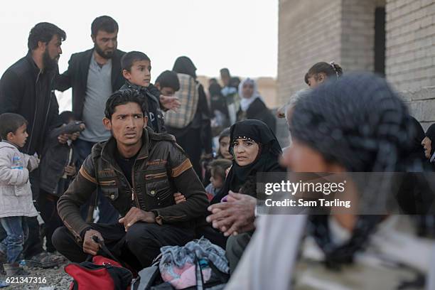 Civilians react after a mortar lands nearby while they wait to be put on lorries as they flee from the Zahara neighbourhood on the north eastern edge...