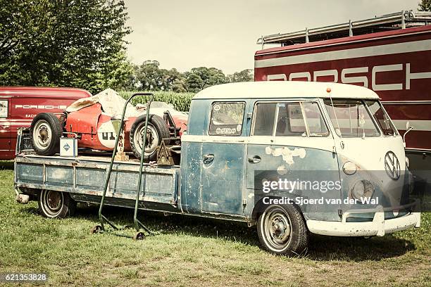 volkswagen transporter flatbed classic truck with a porsche race car - combi van stock pictures, royalty-free photos & images