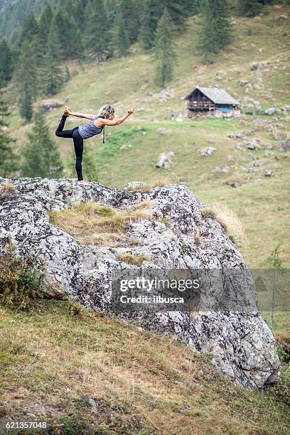 yoga exercises in nature: dancer pose - lord of the dance pose stock pictures, royalty-free photos & images