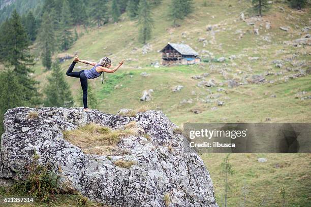 yoga exercises in nature: dancer pose - lord of the dance pose stock pictures, royalty-free photos & images