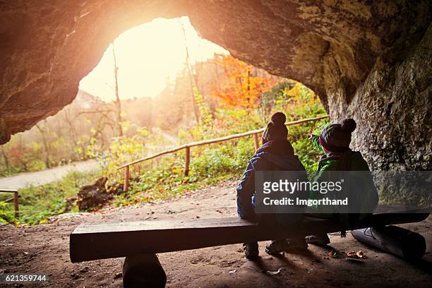 little hikers resting in a cave - krakow park stock pictures, royalty-free photos & images