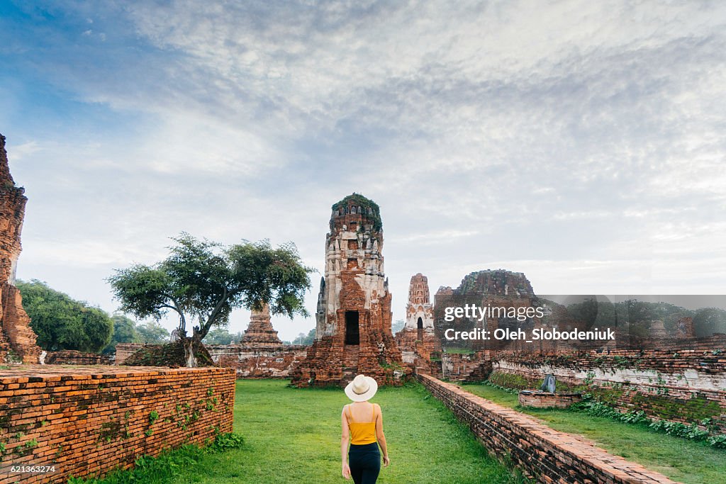 Woman walking near  ancient Buddhist Temple