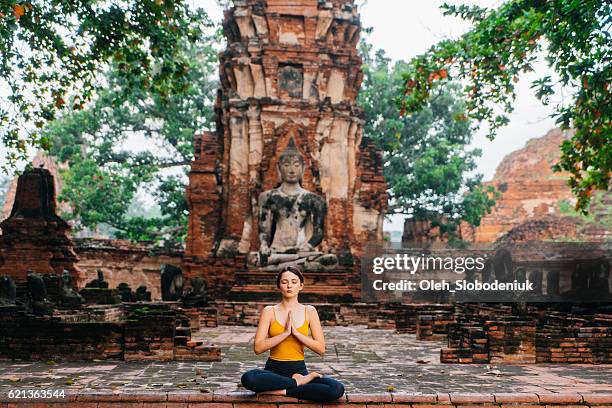 woman doing yoga near the ruins of buddhist temple - namaste bildbanksfoton och bilder