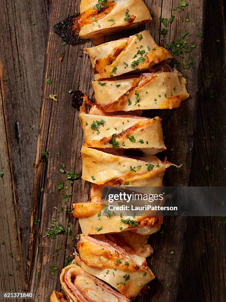 stromboli with pepperoni, salami, mushrooms and peppers - strudel stock pictures, royalty-free photos & images