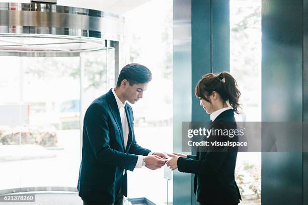 the traditional exchanging of a business card - woman bowing stock pictures, royalty-free photos & images