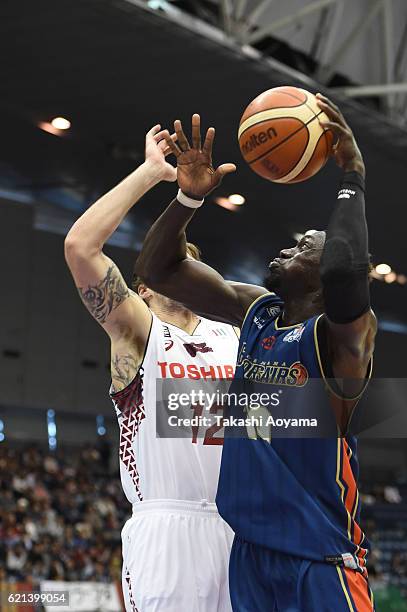 Faye Pape Mour of the Yokohama B-Corsairs tries to shoot under pressure from Ryan Spangler of the Kawasaki Brave Thunders during the B. League match...