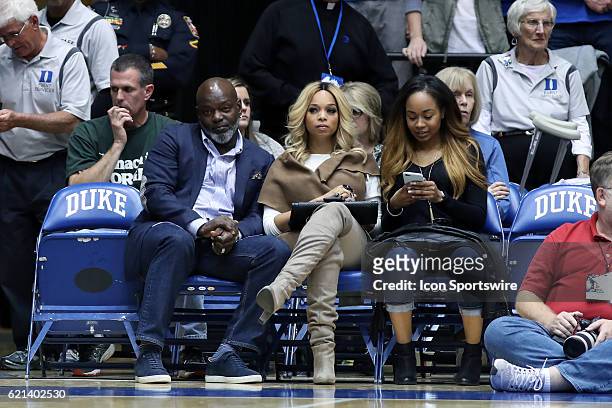 Retired NFL and Dallas Cowboys star Emmett Smith watches the game courtside with his wife Patricia Southall and his daughter, Duke student Jasmin...