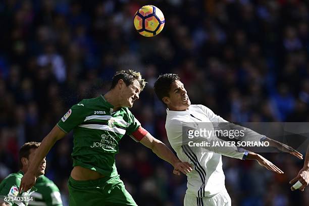 Real Madrid's French defender Raphael Varane vies with Leganes's defender Bustinza during the Spanish league football match Real Madrid CF vs Club...