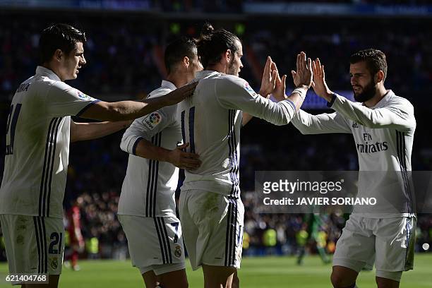 Real Madrid players celebrate after scoring a goal during the Spanish league football match Real Madrid CF vs Club Deportivo Leganes SAD at the...