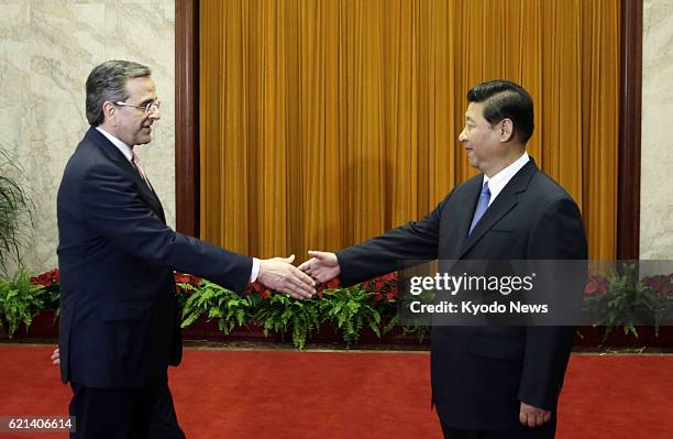 China - Greek Prime Minister Antonis Samaras and Chinese President Xi Jinping shake hands at the Great Hall of the People in Beijing on May 17, 2013.