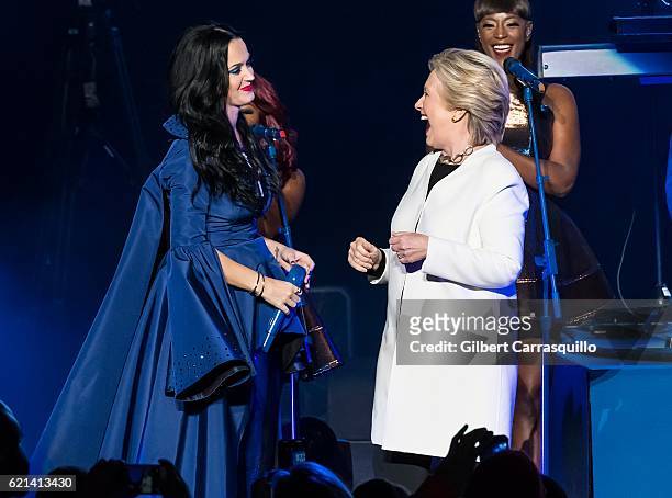 Singer-songwriter, Katy Perry and Democratic presidential nominee former Secretary of State Hillary Rodham Clinton on stage during Katy Perry holds...