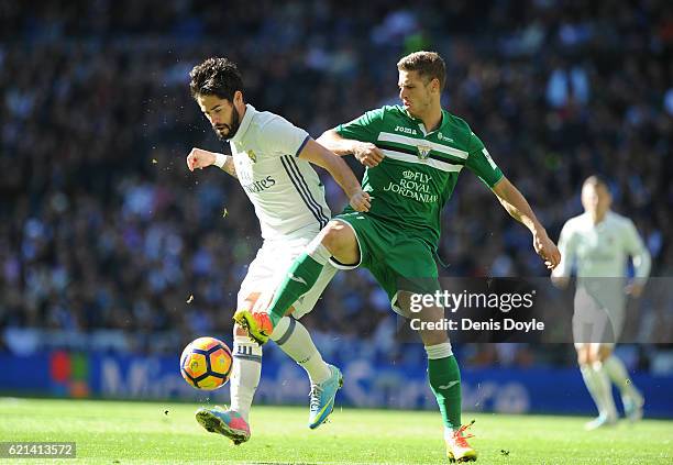 Isco of Real Madrid is tackled by Ruben Perez of CD Leganes during the Liga match between Real Madrid CF and Leganes on November 6, 2016 in Madrid,...