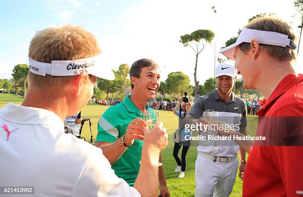 Thorbjorn Olesen of Denmark celebrates with champagne and his fellow Danish golfers Lucas Bjerregaard, Lasse Jensen and Soren Kjeldsen following his...