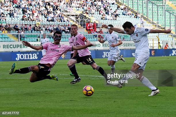 Milan's midfielder from Italy Giacomo Bonaventura kicks the ball in front of Palermo's defender from Slovenia Sinisa Andelkovic during the Italian...