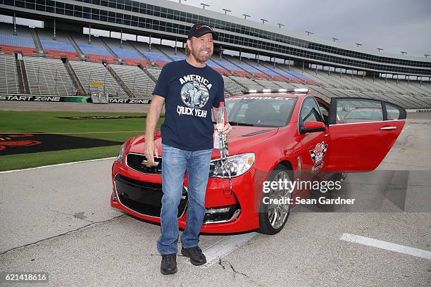 Actor Chuck Norris poses with the AAA Texas 500 pace car prior to the NASCAR Sprint Cup Series AAA Texas 500 at Texas Motor Speedway on November 6,...
