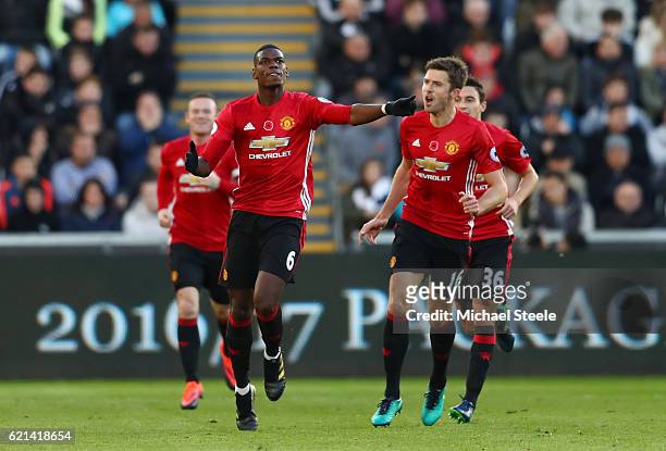 Paul Pogba of Manchester United celebrates scoring his sides first goal with Michael Carrick during the Premier League match between Swansea City and...